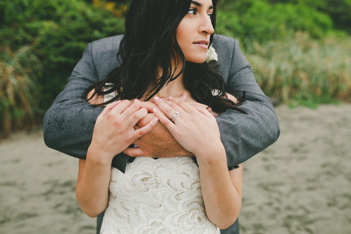 groom embracing bride from behind