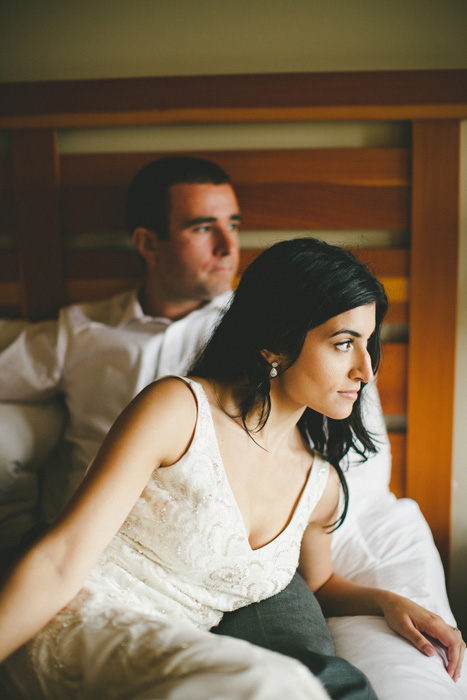 bride and groom sitting on the bed