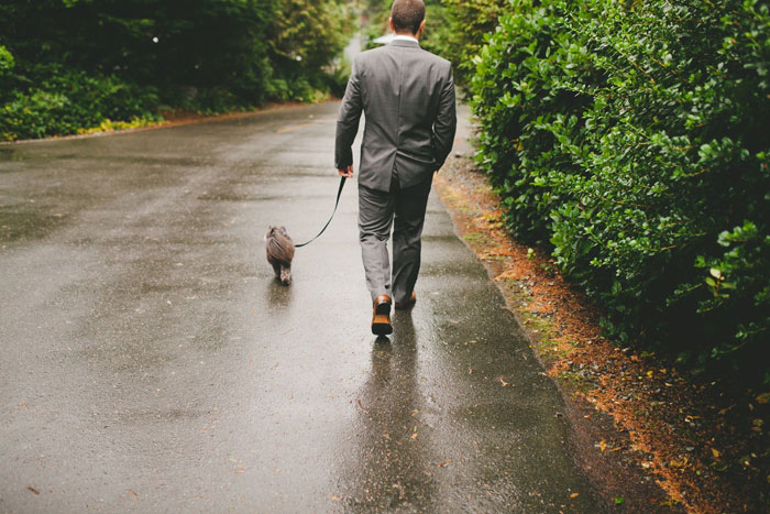 groom walking his dog