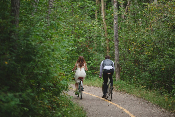 bride and groom riding down the road