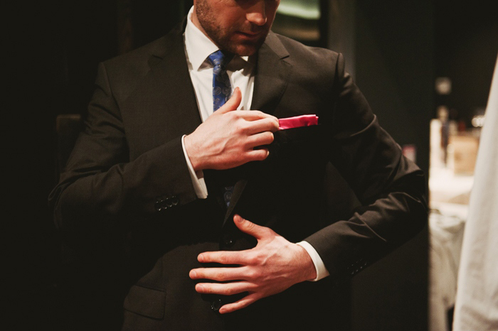 groom adjusting pocket square