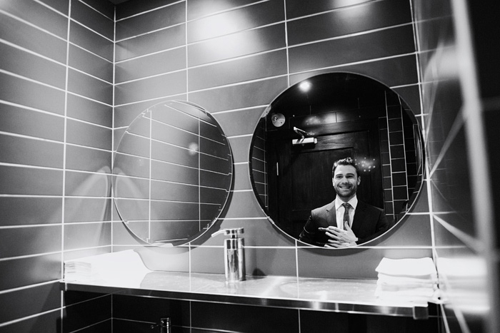 groom's reflection in mirror