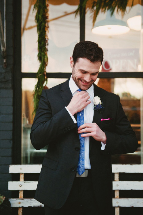 groom adjusting his tie