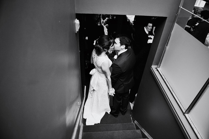bride and groom kissing on the stairs
