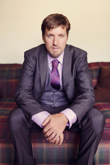 groom in purple shirt and tie