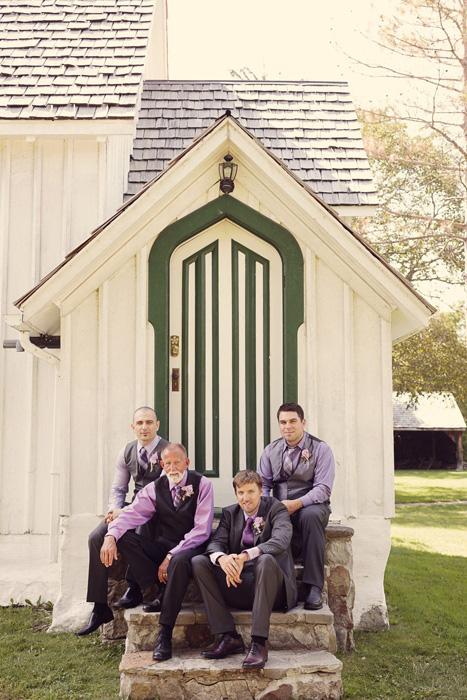 groomsmen sitting on stone steps