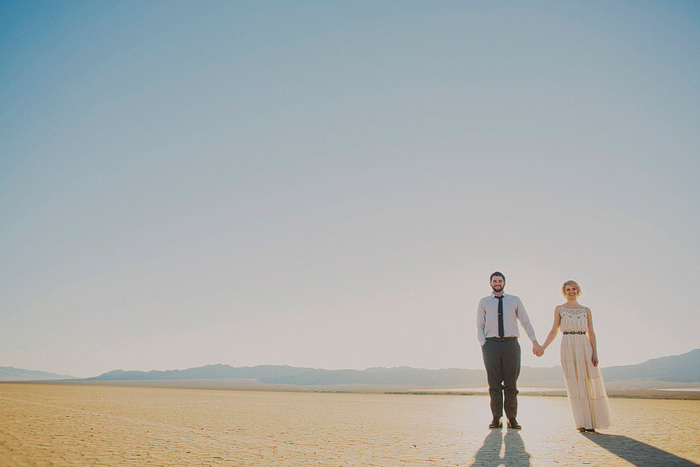 bride and groom standing in dry lake bed