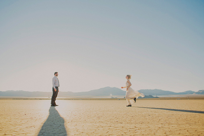 bride running through the desert towards groom