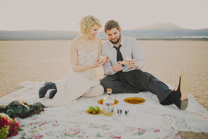 bride and groom having a picnic in the desert