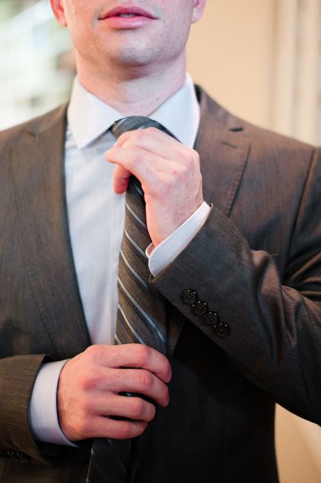 groom adjusting tie