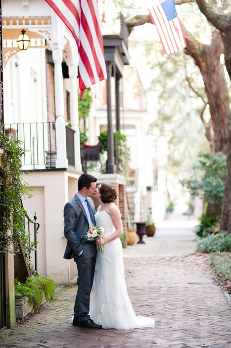 bride and groom kissing in the street