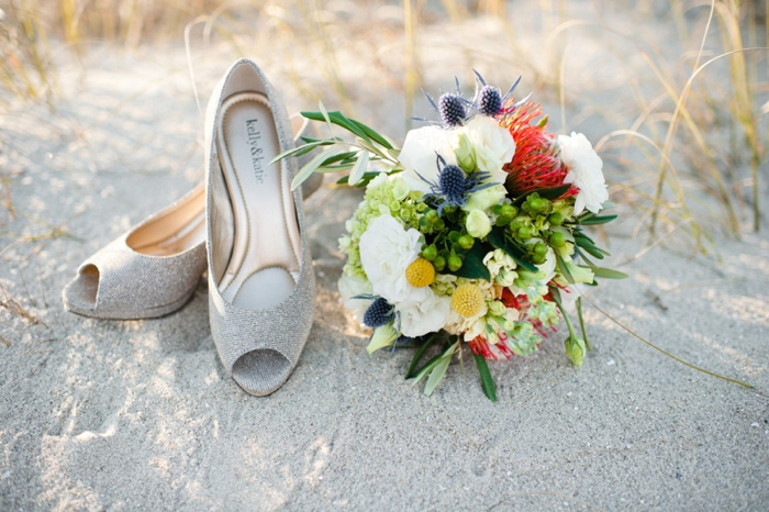 bouquet and shoes on the beach