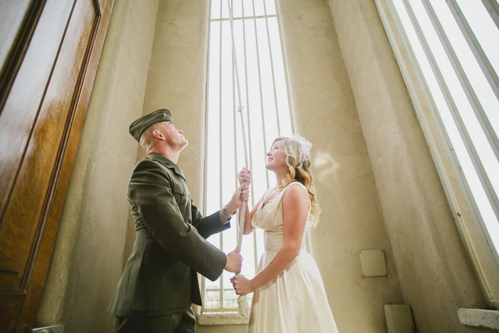 bride and groom ringing chapel bell