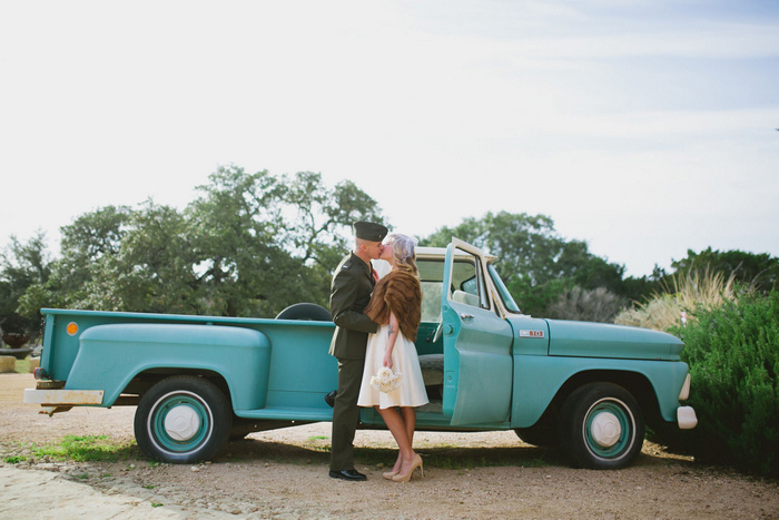 bride and groom kissing in front of vintage pick-up truck