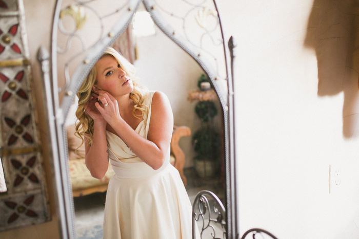 bride putting on her earrings