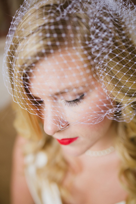 bride with red lip and birdcage veil