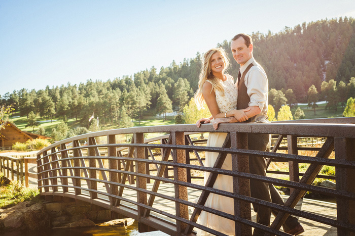 bride and groom on wooden bridge