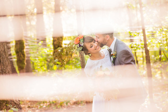 groom kissing bride on the cheek