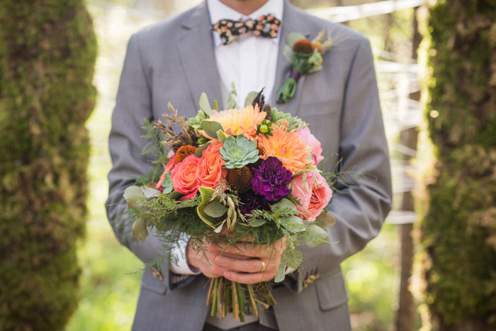 groom holding wedding bouquet