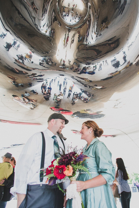 bride and groom under art installation