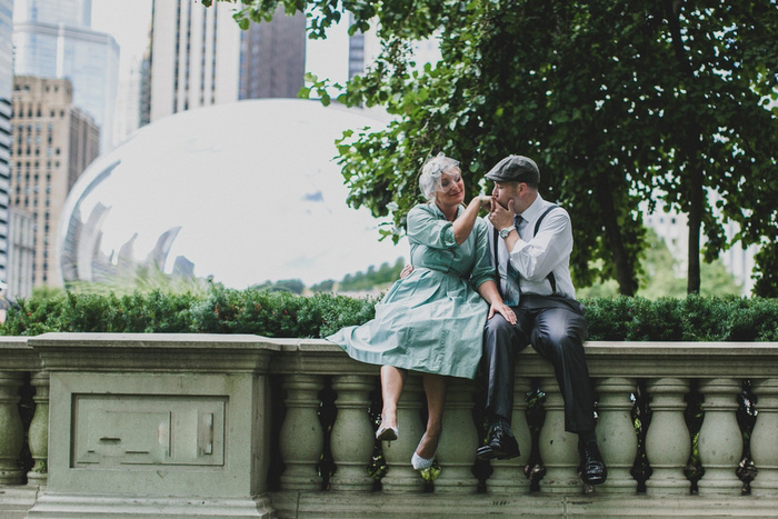 bride and groom sitting in park