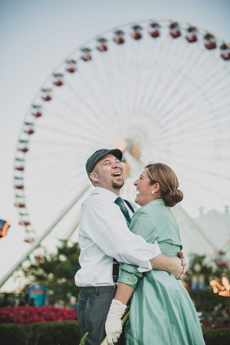 bride and groom by Ferris wheel