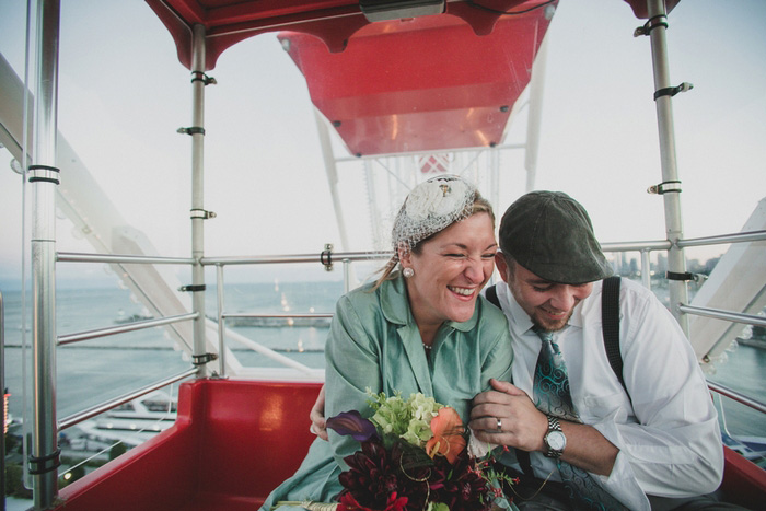 bride and groom on Ferris wheel