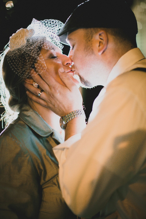 bride and groom kiss at night