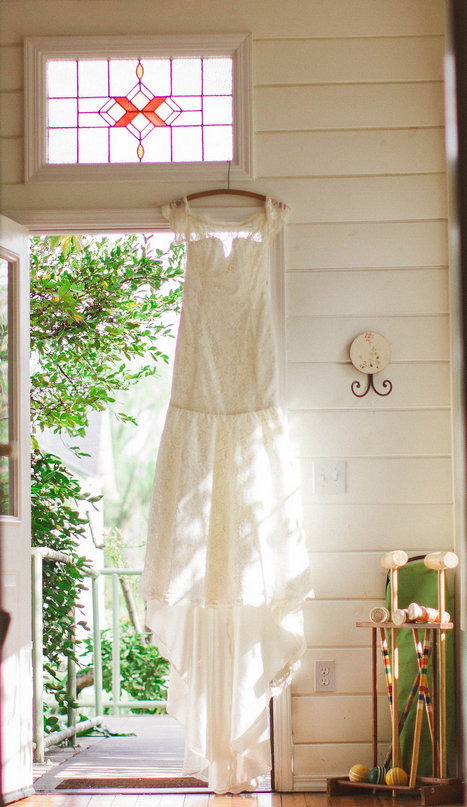 Wedding dress hangin in doorway