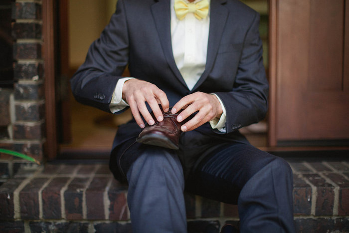 groom putting on shoes