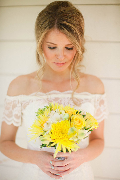 bride with yellow wedding bouquet