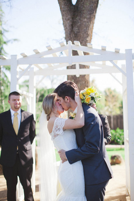 bride and groom first kiss