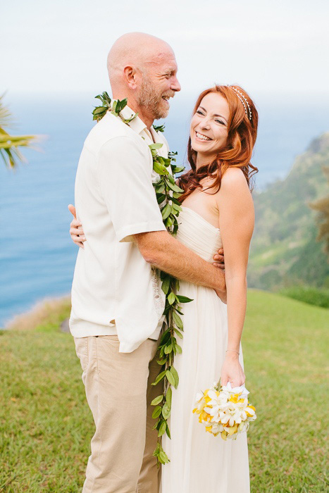 bride and groom portrait on cliff by the ocean