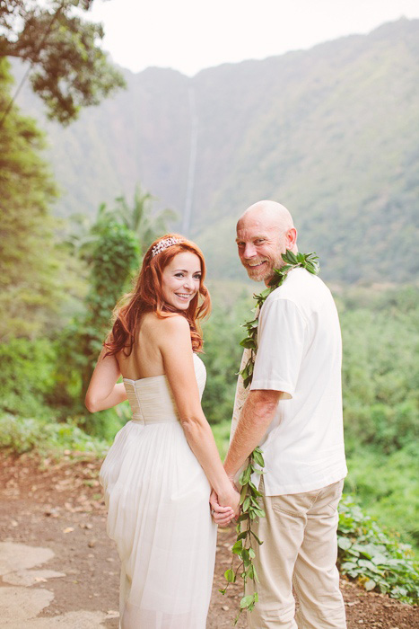 bride and groom walking down dirt road