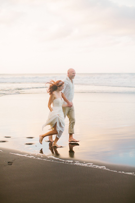 bride and groom running on the beach