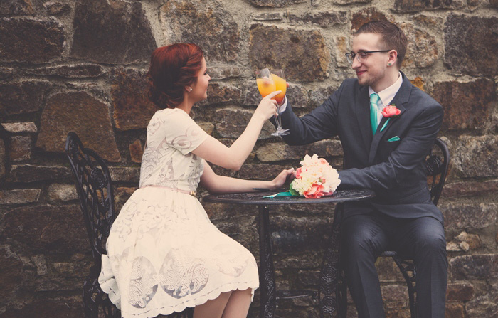 bride and groom drinking mimosas