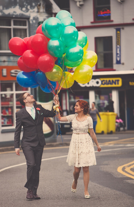 bride and groom with lots of balloons