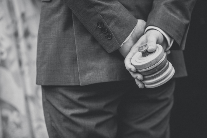 groom holding ring box