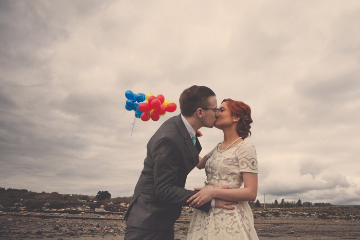 bride and groom kissing on beach