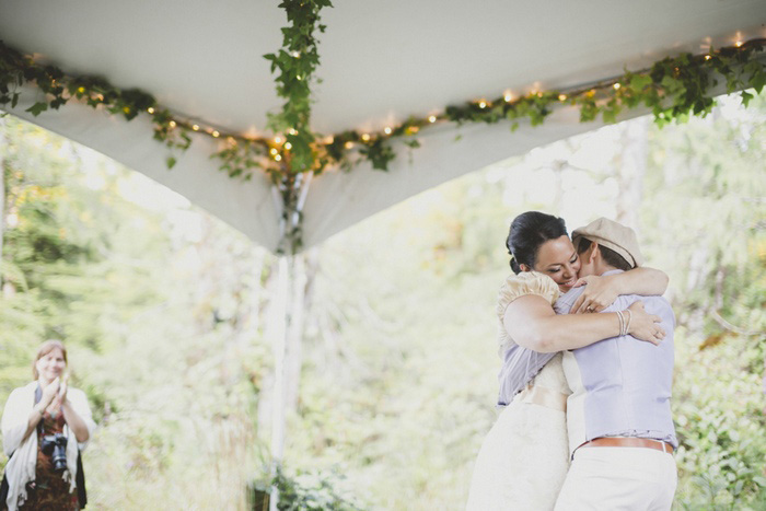 brides hugging on dance floor