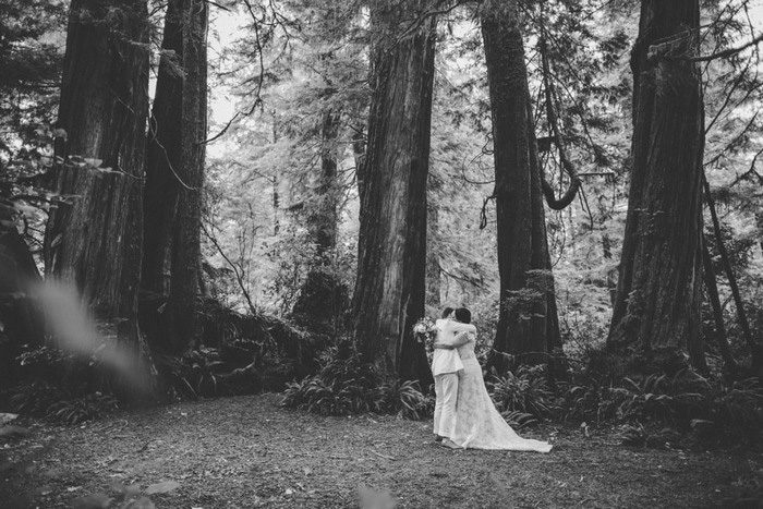 brides hugging in the woods