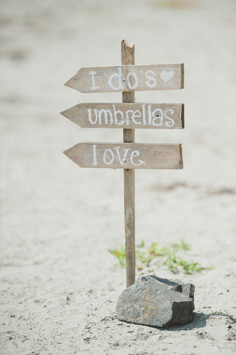 wooden wedding signs on the beach