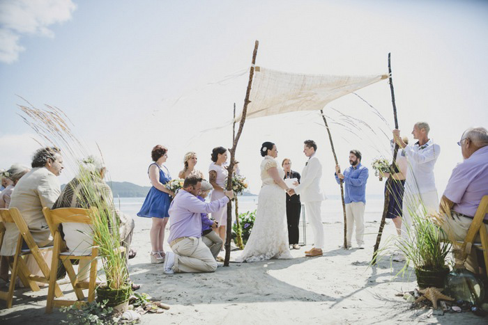 beach wedding ceremony under canopy