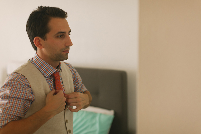 groom adjusting his tie