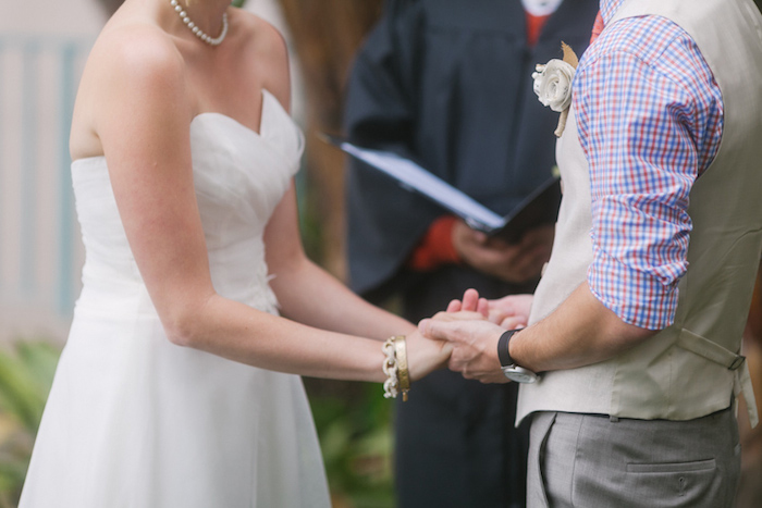 bride and groom holding hands during ceremony