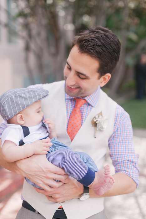 groom holding baby son