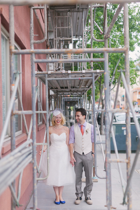 bride and groom under scaffolding