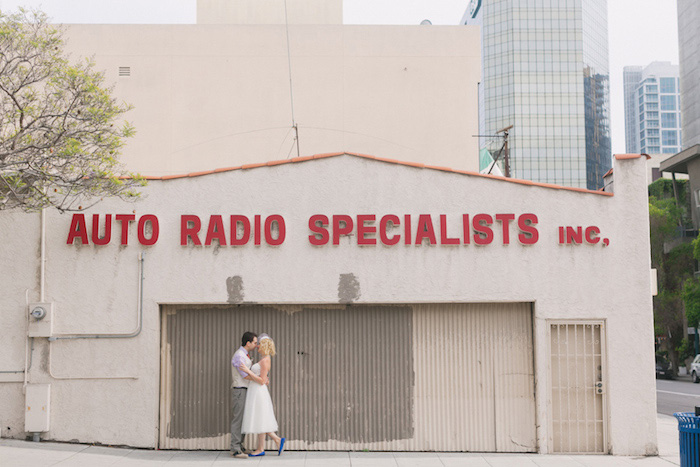 bride and groom in front of old building