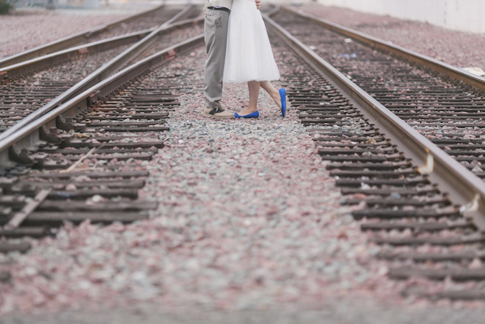 bride and groom on train tracks