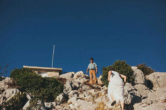 bride climbing cliff